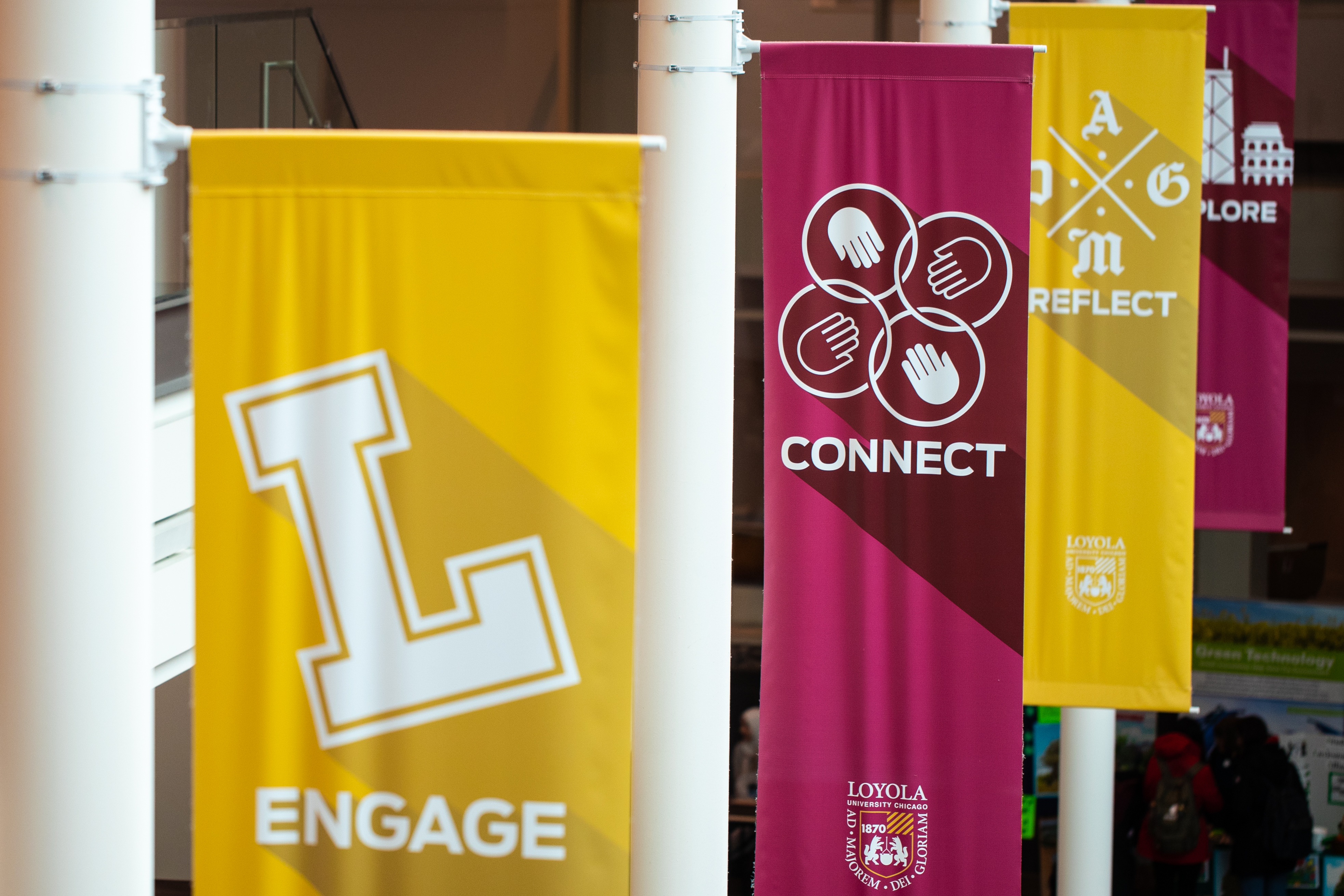 Loyola Gold and Maroon flags that read 